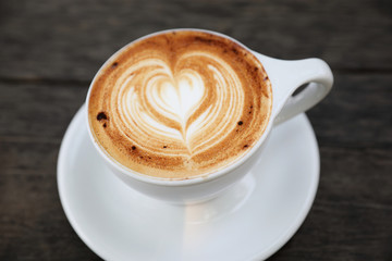 Cappuccino coffee cup on wood background
