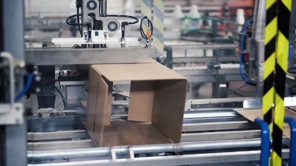 Cardboard package box packing machine. Clip. Box forming production line