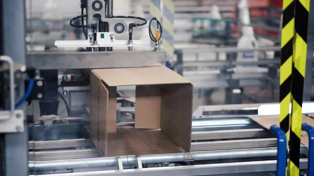 Cardboard package box packing machine. Clip. Box forming production line