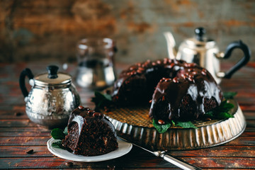 Sweet chocolate cake with cacao icing and decorated with mint