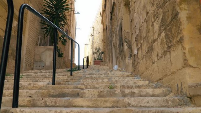 Walking along the medieval streets of Valletta, Malta.