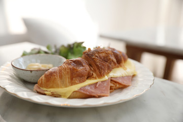 Sandwich ham and cheese on white table in coffee shop