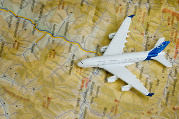 Fototapeta na wymiar Airplane on the map. Travel concept. Close up