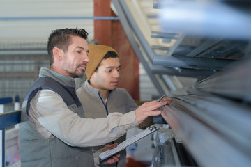 two worker in factory on the machine