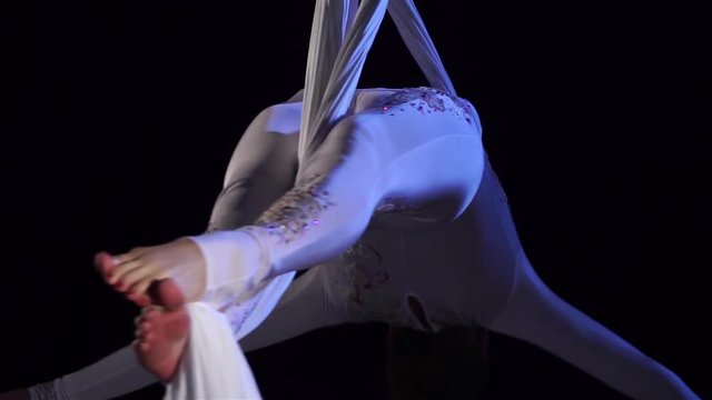 woman dancer on aerial silk, aerial contortion, aerial ribbons. Slow Motion