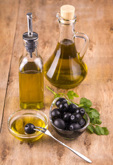 Olives and Healthy Olive oil bottles and cup with parsley