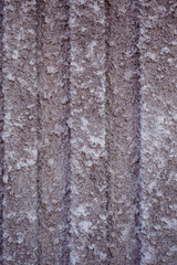 Obraz premium Brown decorative plaster on the wall with lines. Art background