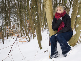 Pretty Woman sat in the woods during a cold winter