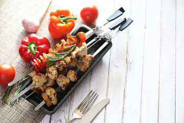 Kebab cooked on metal skewers with vegetables