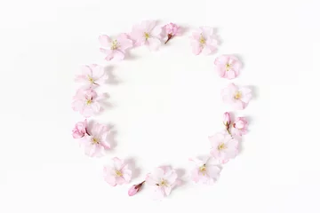 Washable wall murals Cherryblossom Styled stock photo. Spring, Easter feminine scene floral composition. Round frame wreath pattern made of pink Japanese cherry blossoms. White background. Flat lay, top view.