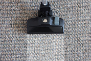 housekeeping before and after concept - modern vacuum cleaner over carpet