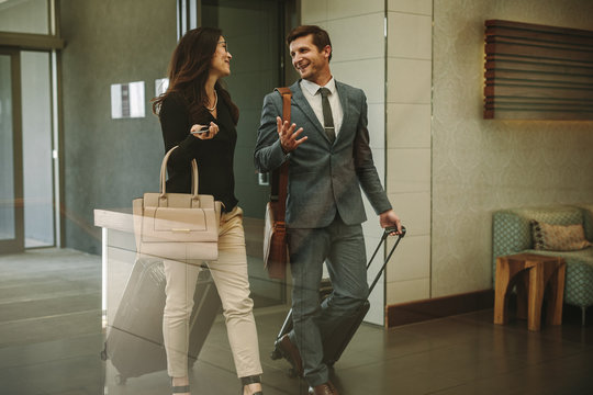 Business partners walking through airport lobby
