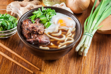Japanese Udon noodles with beef, egg, green onion and soup