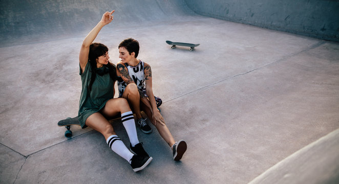 Female friends hanging out at skate park