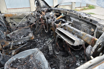 The car salon after a fire. Burned car interior after a fire, front panel, all burnt out