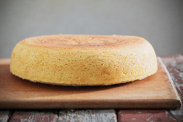 sponge cake on old wooden table.