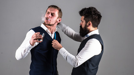 Client with strict face smoke cigar and drink whiskey