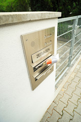 Mailbox on the house fence. Modern mailbox of the house filled with newspapers.