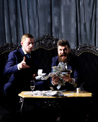 Man holds cash, money, banknotes. Luxury life concept.