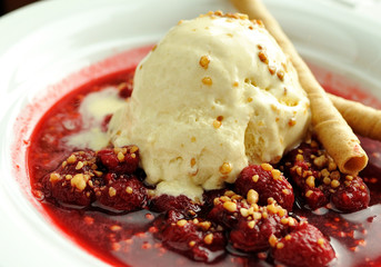 Ice cream with blackberries. Delicious vanilla ice cream dessert with blackberries and chocolate rolls.