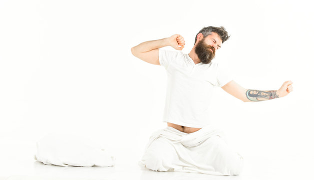 Hipster with beard stretching arms, energetic and successful