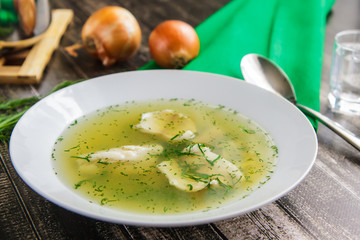 Fresh fish soup with ingredients and spices. Wooden background