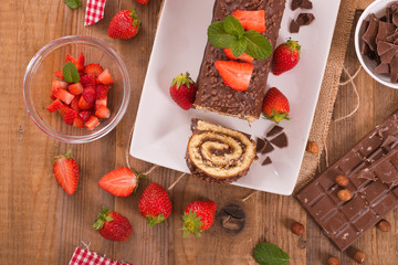 Chocolate roll with strawberries. 