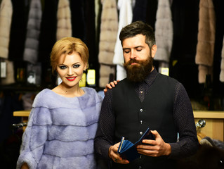 Fashion and shopping concept. Customer with beard and woman