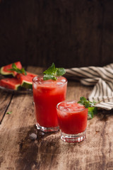 Refreshing summer watermelon juice in glasses with slices of watermelon