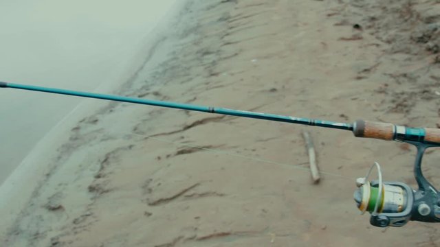 The roach fell from the hook The fisherman sharply marked and pulled out the roach, but the fish broke off the hook and jumped to the river 