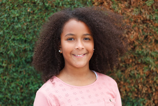 Portrait of beautiful girl with afro hair in a park