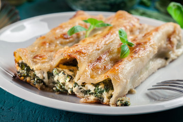 Portion of cannelloni stuffed with spinach