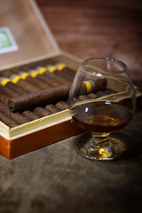 Large box of Cuban cigars on a wooden table