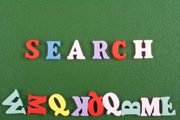 SEARCH word on green background composed from colorful abc alphabet block wooden letters, copy space for ad text. Learning english concept.