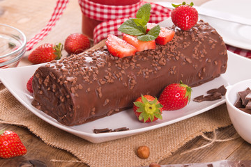 Chocolate roll with strawberries. 