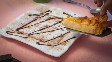 cheesecake with apple and chocolate syrup