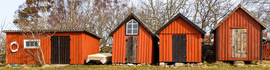 Red and black traditional wooden fishing sheds. Location Ispeudde on Oland, Sweden.