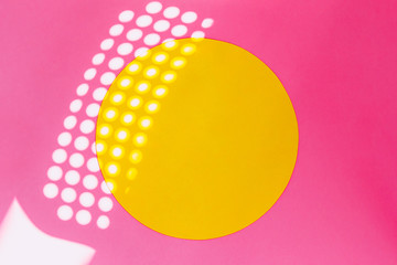 sunbeams reflected on bright pink wall with yellow circle. minimal and surreal creative concept