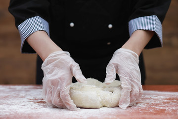 Obraz na płótnie Canvas the cook makes flour for baking on the table