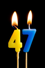 Burning candles in the form of 46 forty six (numbers, dates) for cake isolated on black background. The concept of celebrating a birthday, anniversary, important date, holiday, table setting