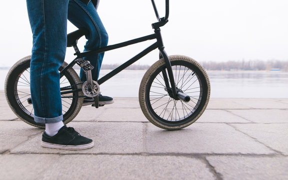 BMX rider stands with a bike in the outdoors. BMX concept. Street style