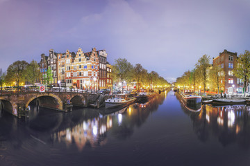 Fototapeta premium Canals of Amsterdam. Moody night panorama of Rossebuurt district