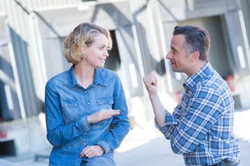Fototapeta premium workers talking while walking in shipping yard