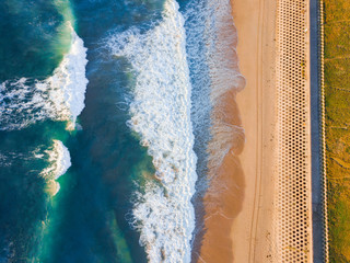 Aerial view of incoming waves and the sea wall.