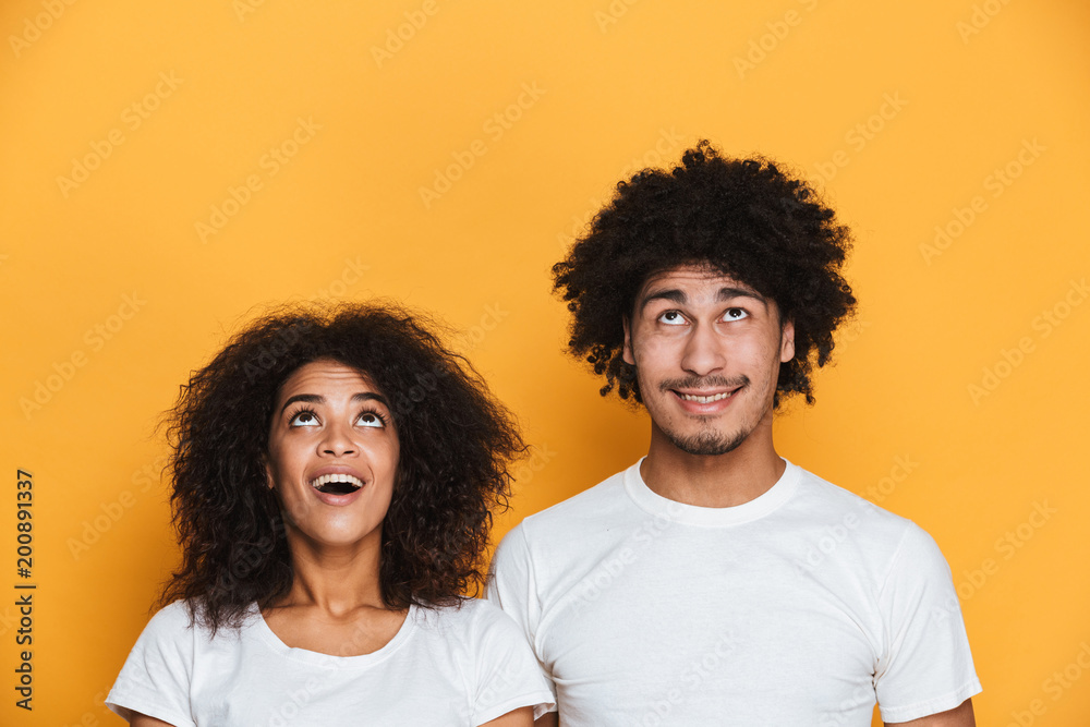 Sticker Portrait of a joyful young afro american couple looking up