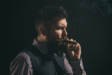 Smoking man on black background. Smoldering cigars. Barber shop concept. Fashionable bearded men. Man with beard and mustache smoke cigar.