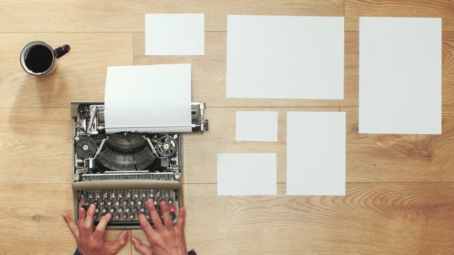 Book writing by the window with a vintage typewriter. 4K video colors and black and white