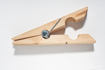 Large wooden clothespin. Isolated white.