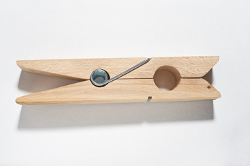 Large wooden clothespin. Isolated white.