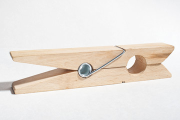 Large wooden clothespin. Isolated white.
